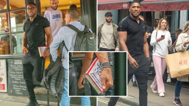 安东尼·约书亚（Anthony Joshua）拿着一本有关政治的书，拳击手被发现在餐厅外与粉丝在一起